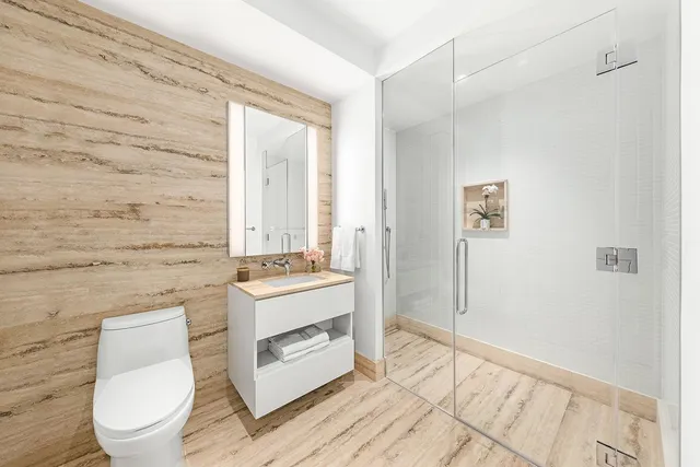 a bathroom with a toilet a sink and a mirror