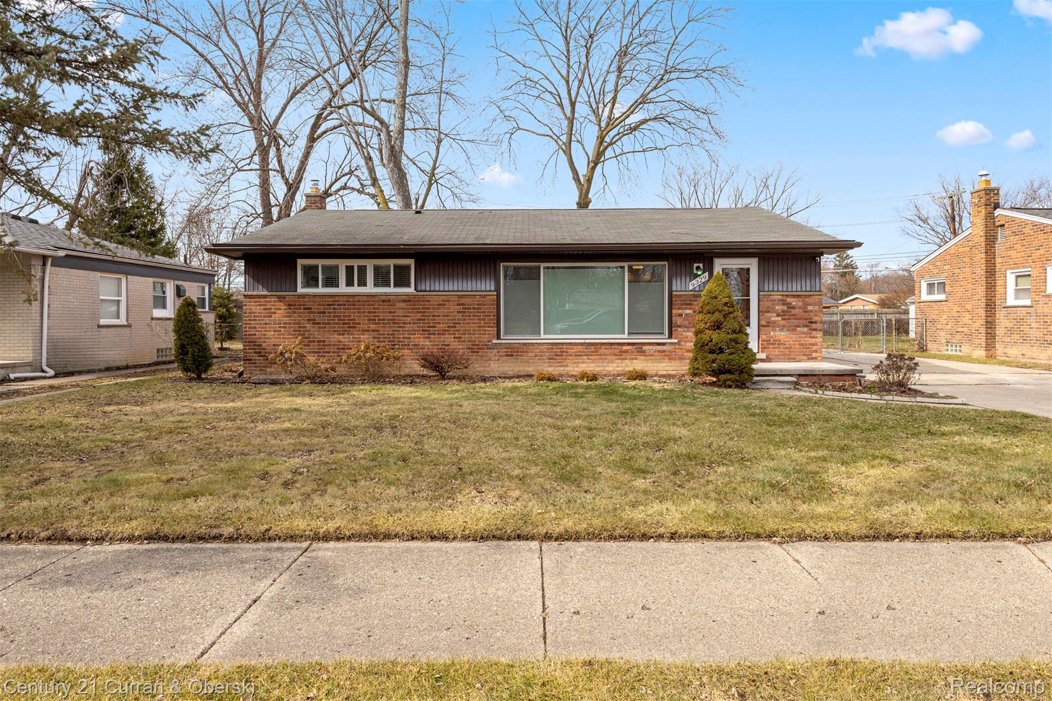 9329 Merriman Road Livonia, MI 48150 - Photo 1 of 32 View of front of house with brick siding, a front lawn, and a chimney