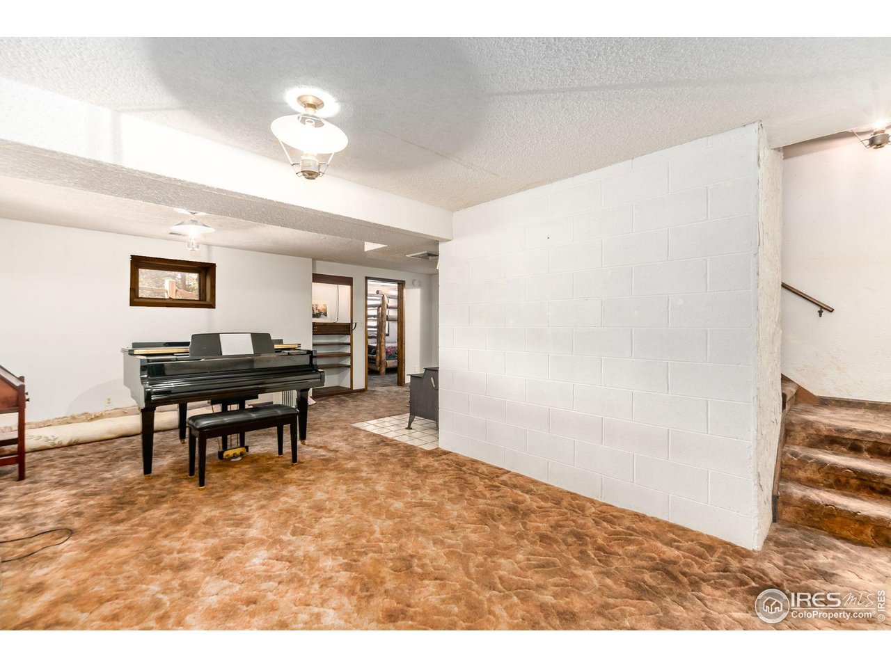 212 Valley Road Lyons, CO 80540 - Photo 19 of 38 a living room with furniture and a piano