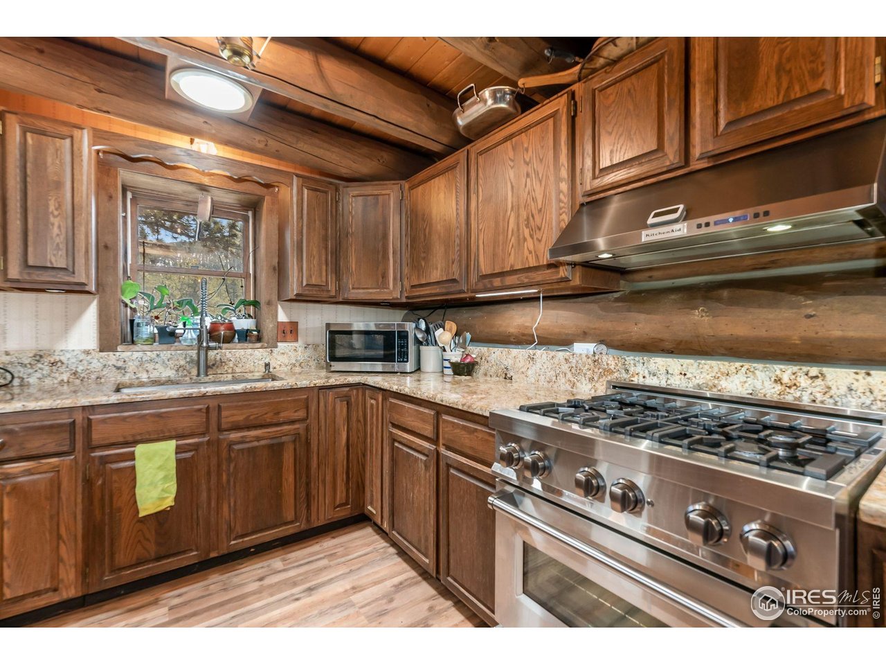212 Valley Road Lyons, CO 80540 - Photo 5 of 38 a kitchen with stainless steel appliances granite countertop a stove and a sink
