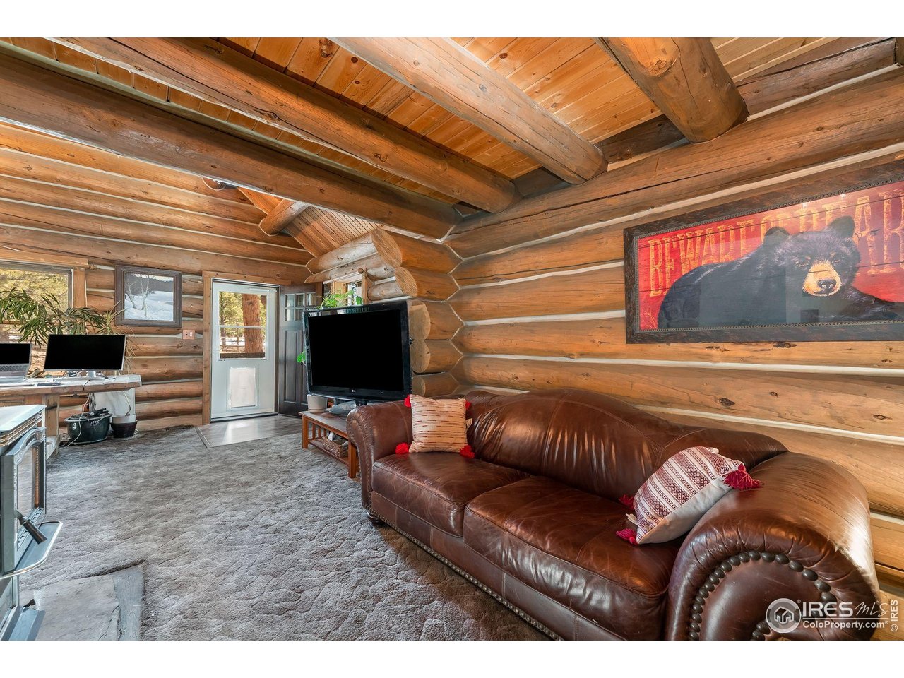 212 Valley Road Lyons, CO 80540 - Photo 10 of 38 a living room with furniture and a flat screen tv
