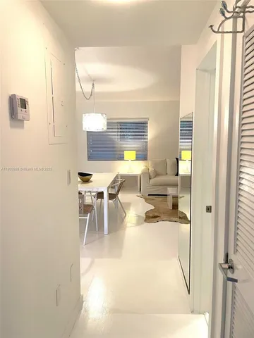 a kitchen with a refrigerator and a stove top oven