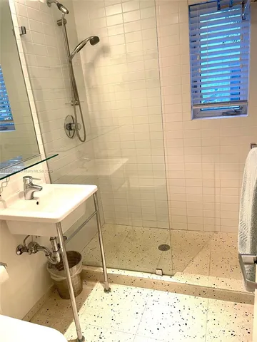 a bathroom with a sink and a shower