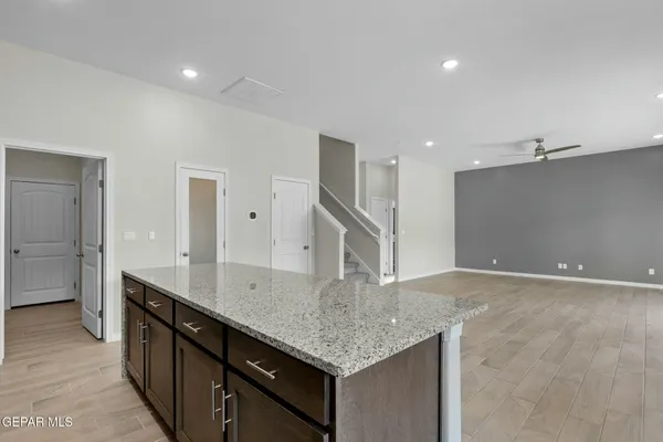 a kitchen with granite countertop a sink and cabinets