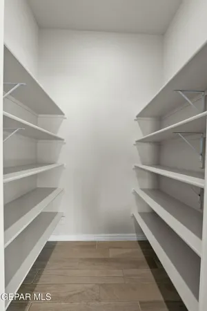 a view of walk in closet with empty racks
