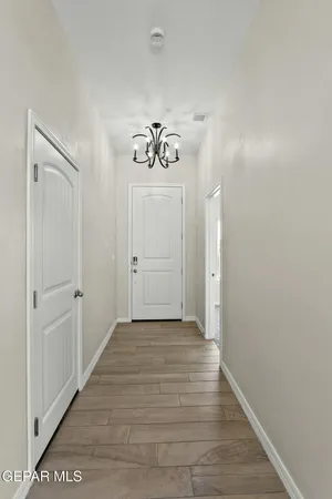 a view of a hallway with wooden floor