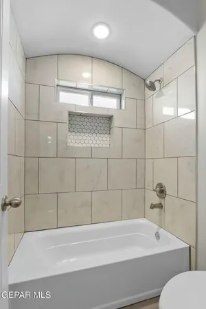 a bathroom with a bathtub and a shower