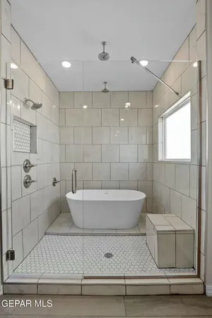 a bathroom with a bathtub and shower