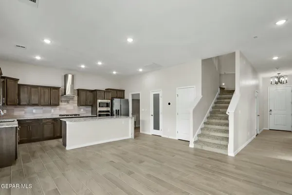 a view of kitchen with granite countertop lots of counter top space