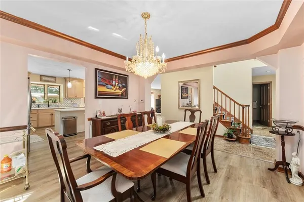 a view of a dining room with furniture and a chandelier