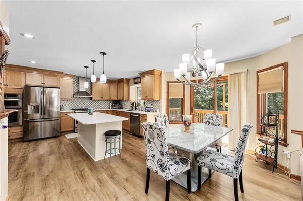 a large kitchen with a table and chairs