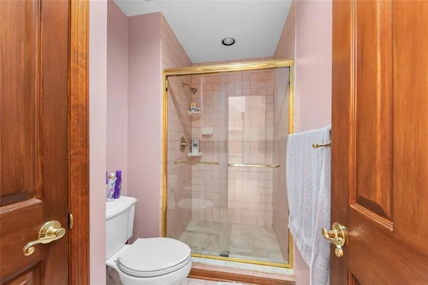 a bathroom with a shower and a toilet