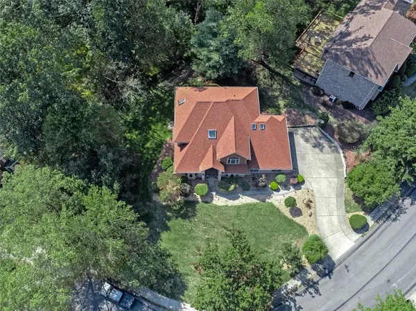 an aerial view of a house with a yard and lake view
