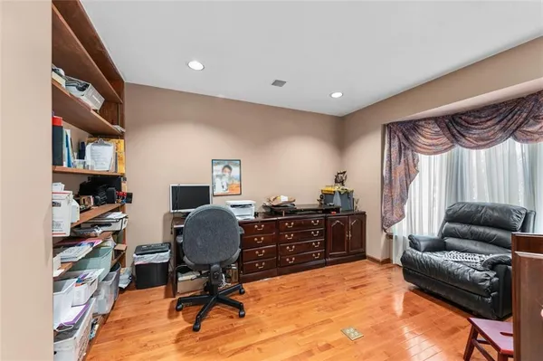 a livingroom with workspace couch and a window