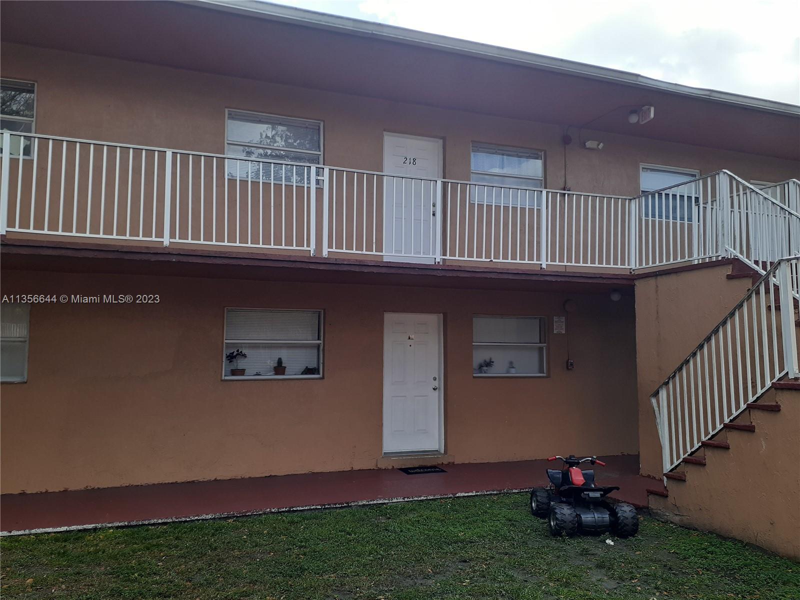 1245 West 24th Street, Unit 118 Hialeah, FL 33010 - Photo 13 of 20 a view of backyard with deck and garden