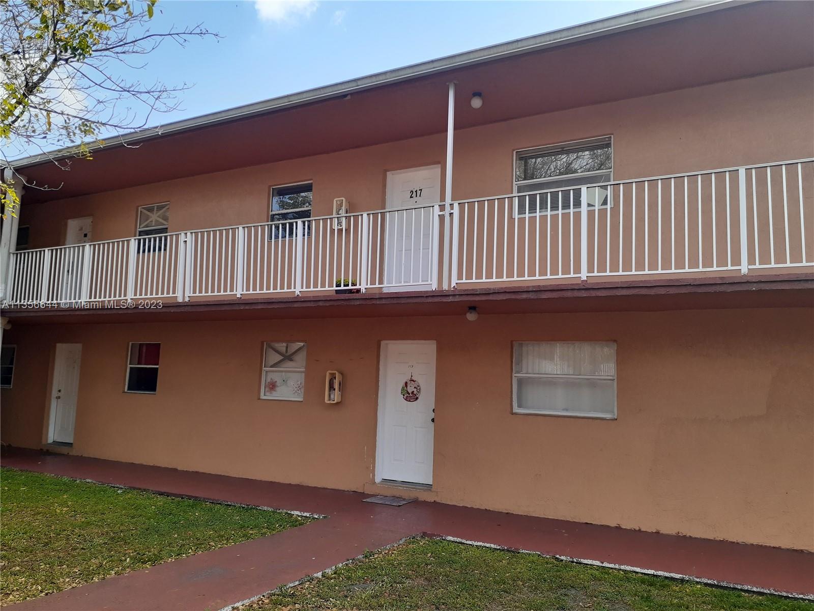 1245 West 24th Street, Unit 118 Hialeah, FL 33010 - Photo 14 of 20 a front view of a house with garden