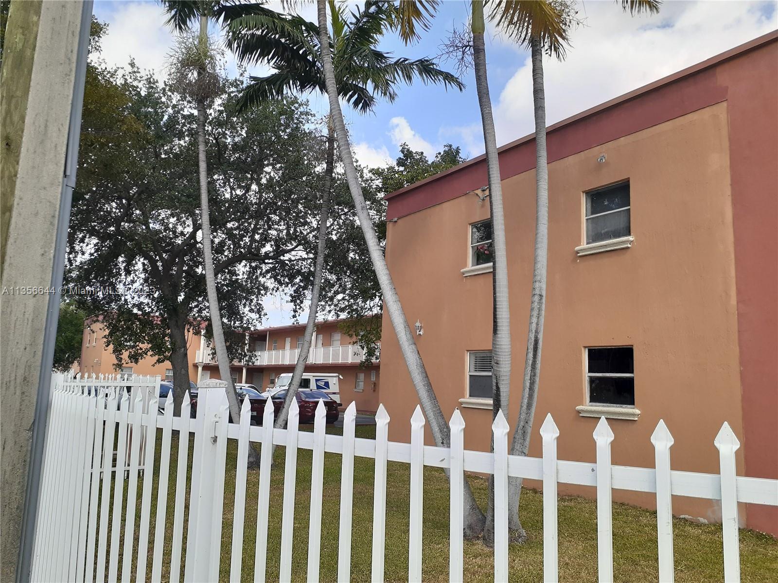 1245 West 24th Street, Unit 118 Hialeah, FL 33010 - Photo 17 of 20 a front view of a house with a tree