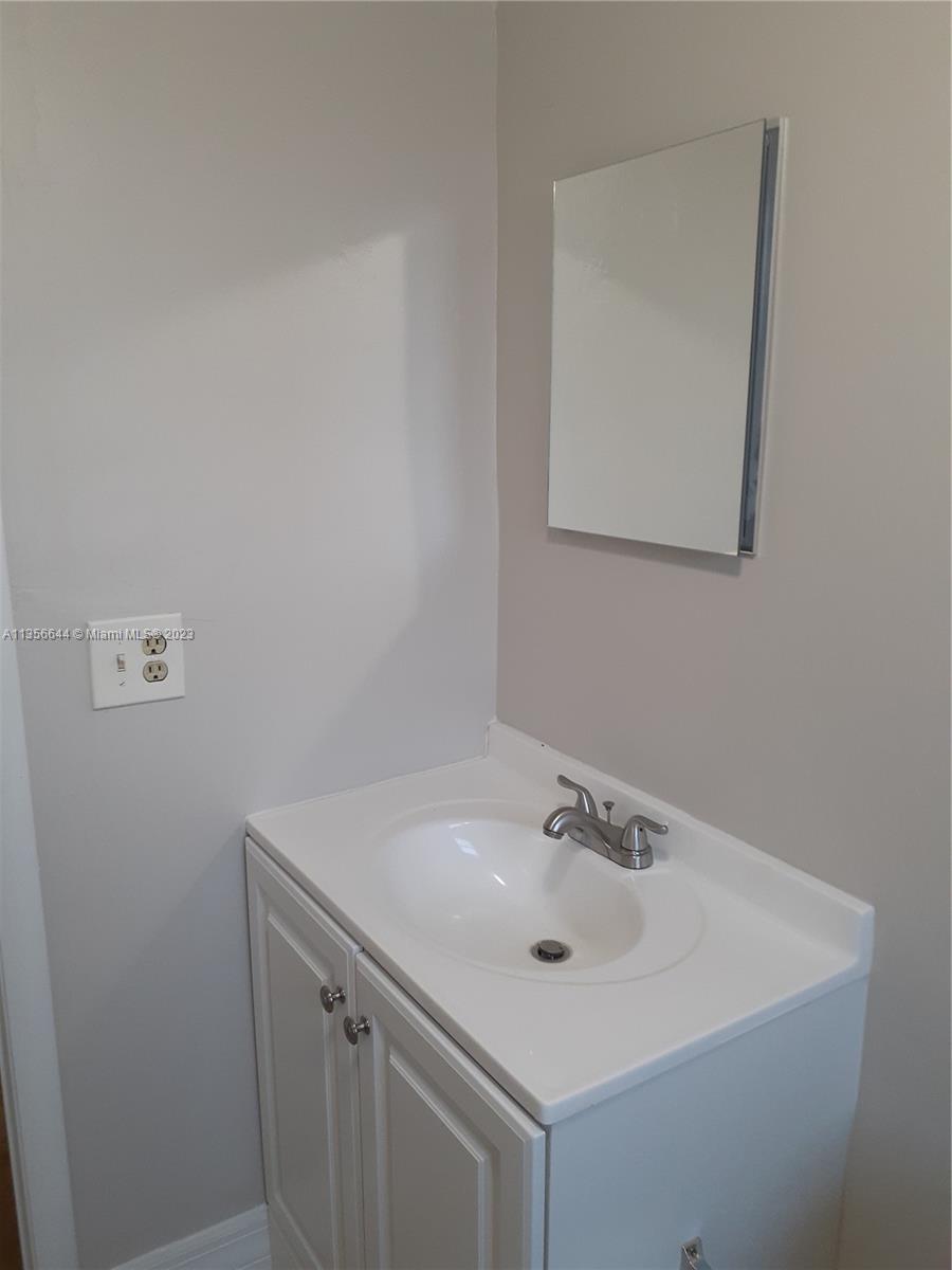 1245 West 24th Street, Unit 118 Hialeah, FL 33010 - Photo 7 of 20 a bathroom with a sink and a mirror
