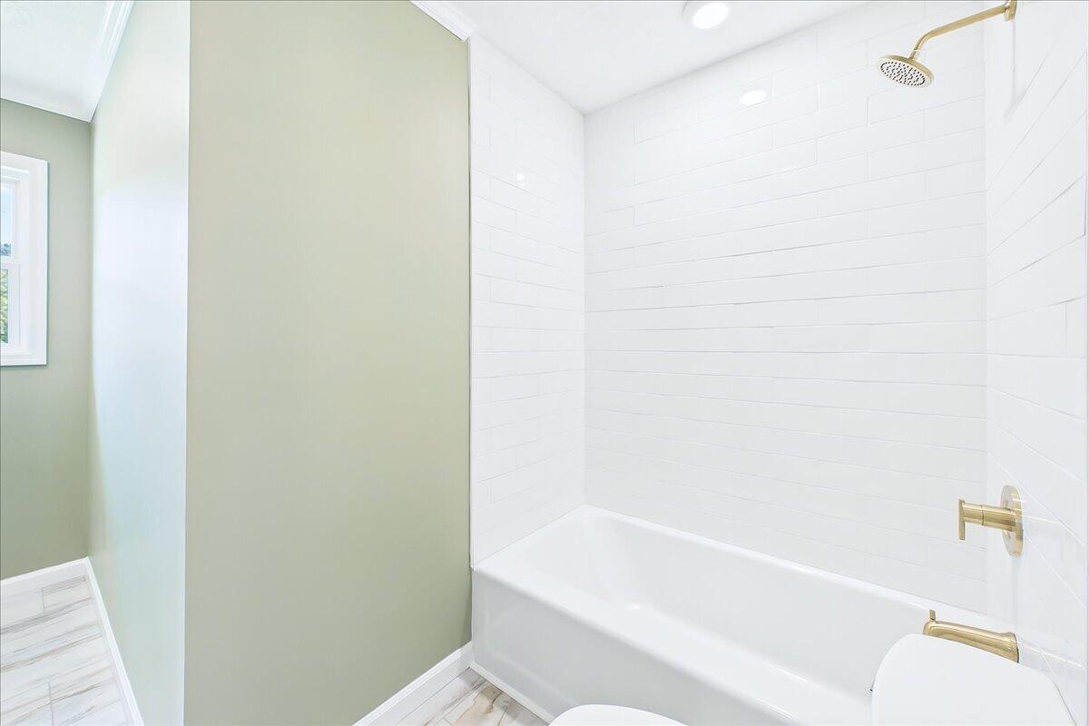 858 Main Street Decatur, TN 37322 - Photo 32 of 65 a bathroom with a bathtub and a toilet