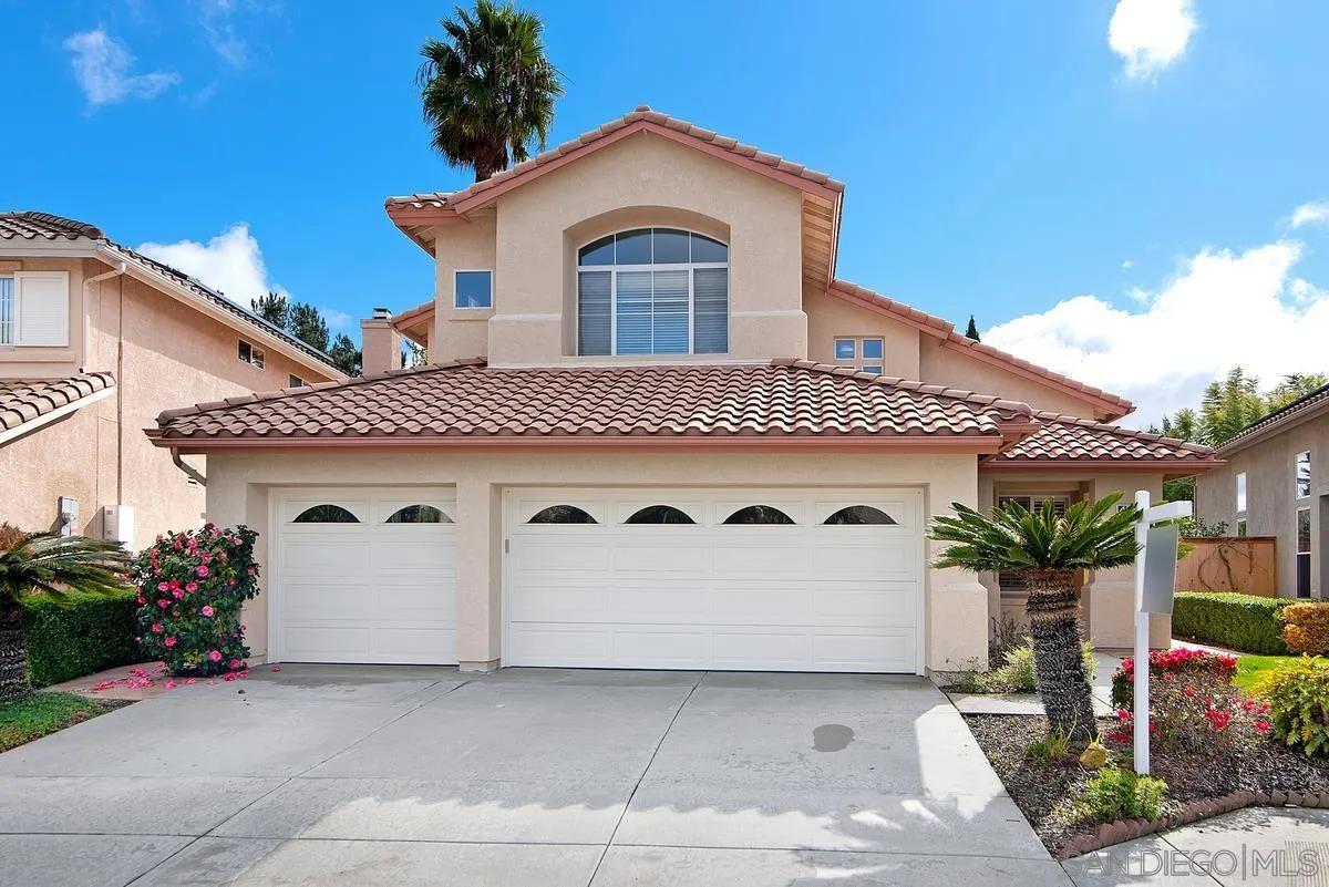 4951 Riding Ridge Road San Diego, CA 92130 - Photo 1 of 32 a front view of a house with a yard