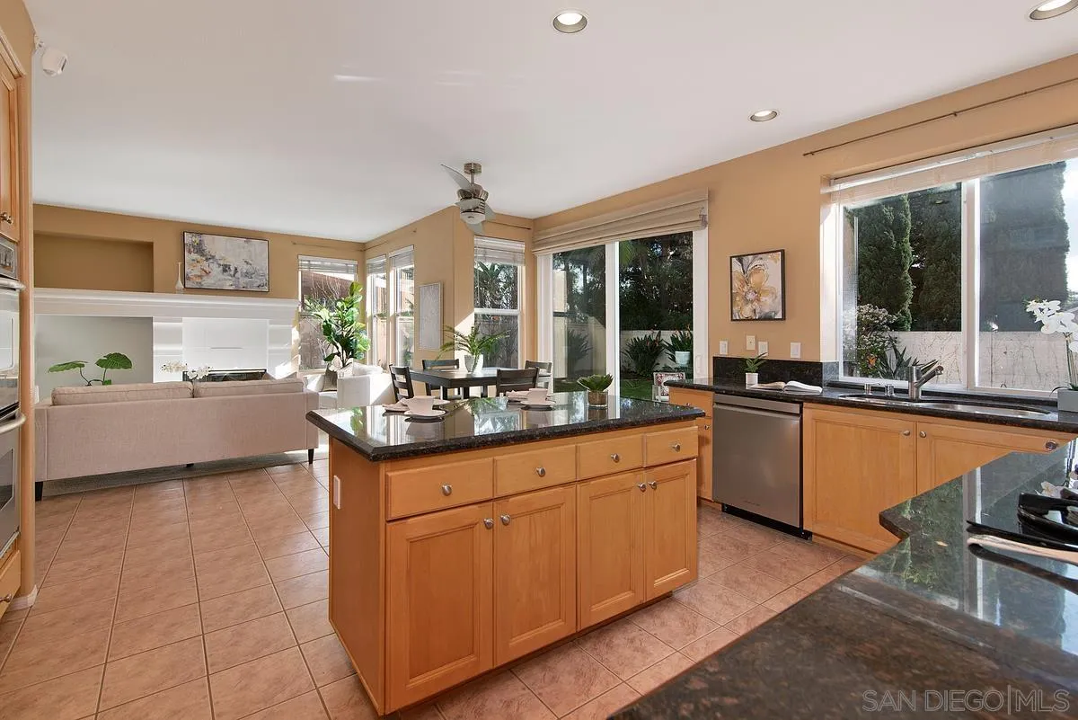 4951 Riding Ridge Road San Diego, CA 92130 - Photo 16 of 32 a kitchen with stainless steel appliances granite countertop a sink and cabinets