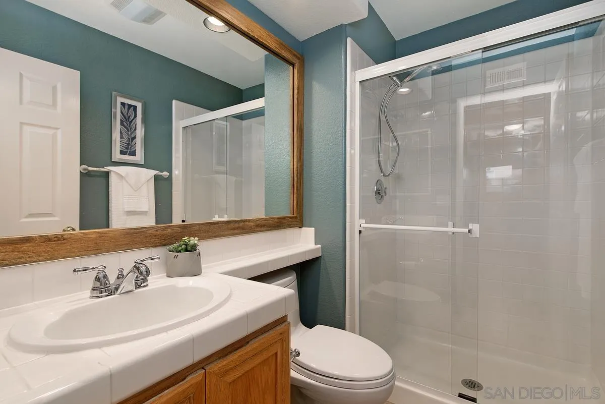 4951 Riding Ridge Road San Diego, CA 92130 - Photo 18 of 32 a bathroom with a sink a toilet and shower