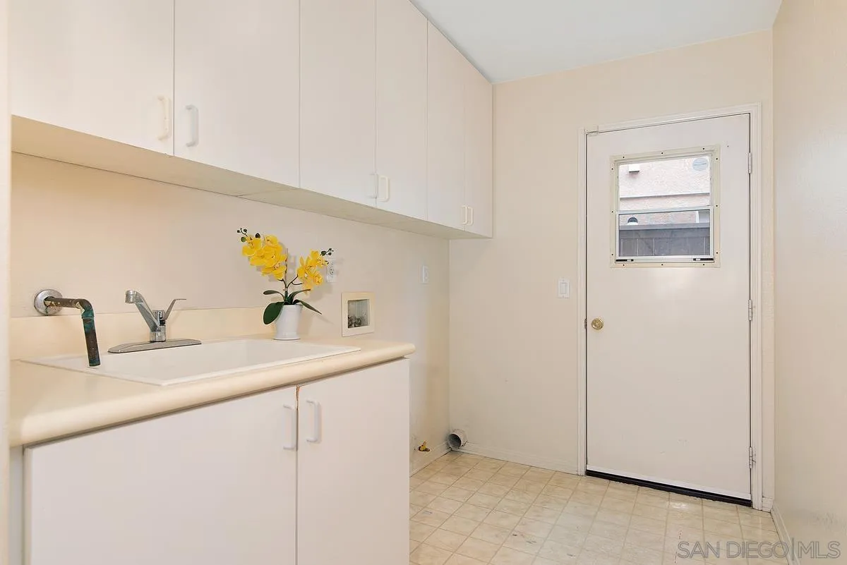 4951 Riding Ridge Road San Diego, CA 92130 - Photo 19 of 32 a kitchen with a sink and a refrigerator