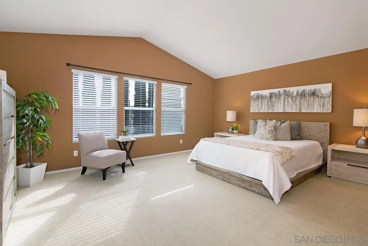 4951 Riding Ridge Road San Diego, CA 92130 - Photo 20 of 32 a spacious bedroom with a bed and a large window