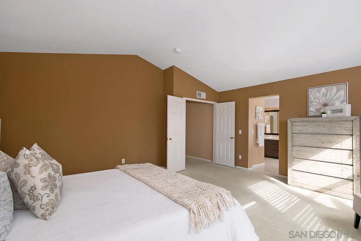 4951 Riding Ridge Road San Diego, CA 92130 - Photo 21 of 32 a bedroom with a bed and a cabinets