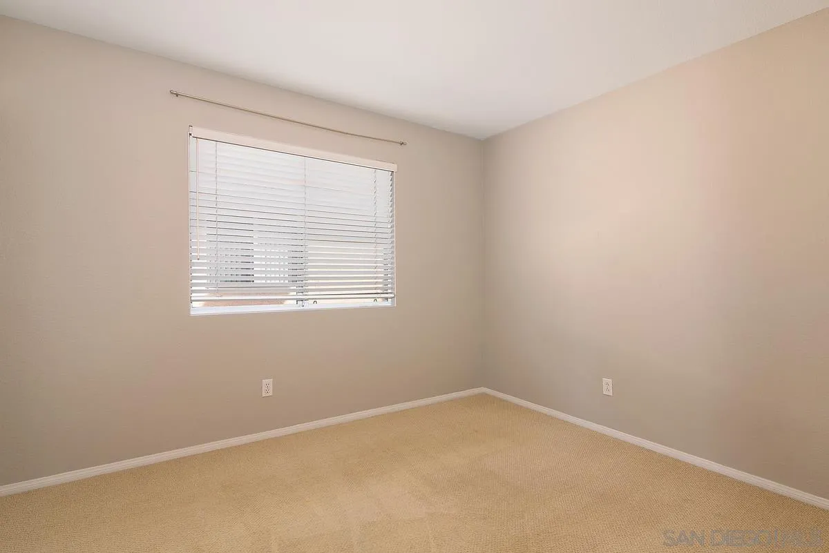 4951 Riding Ridge Road San Diego, CA 92130 - Photo 25 of 32 an empty room with a window