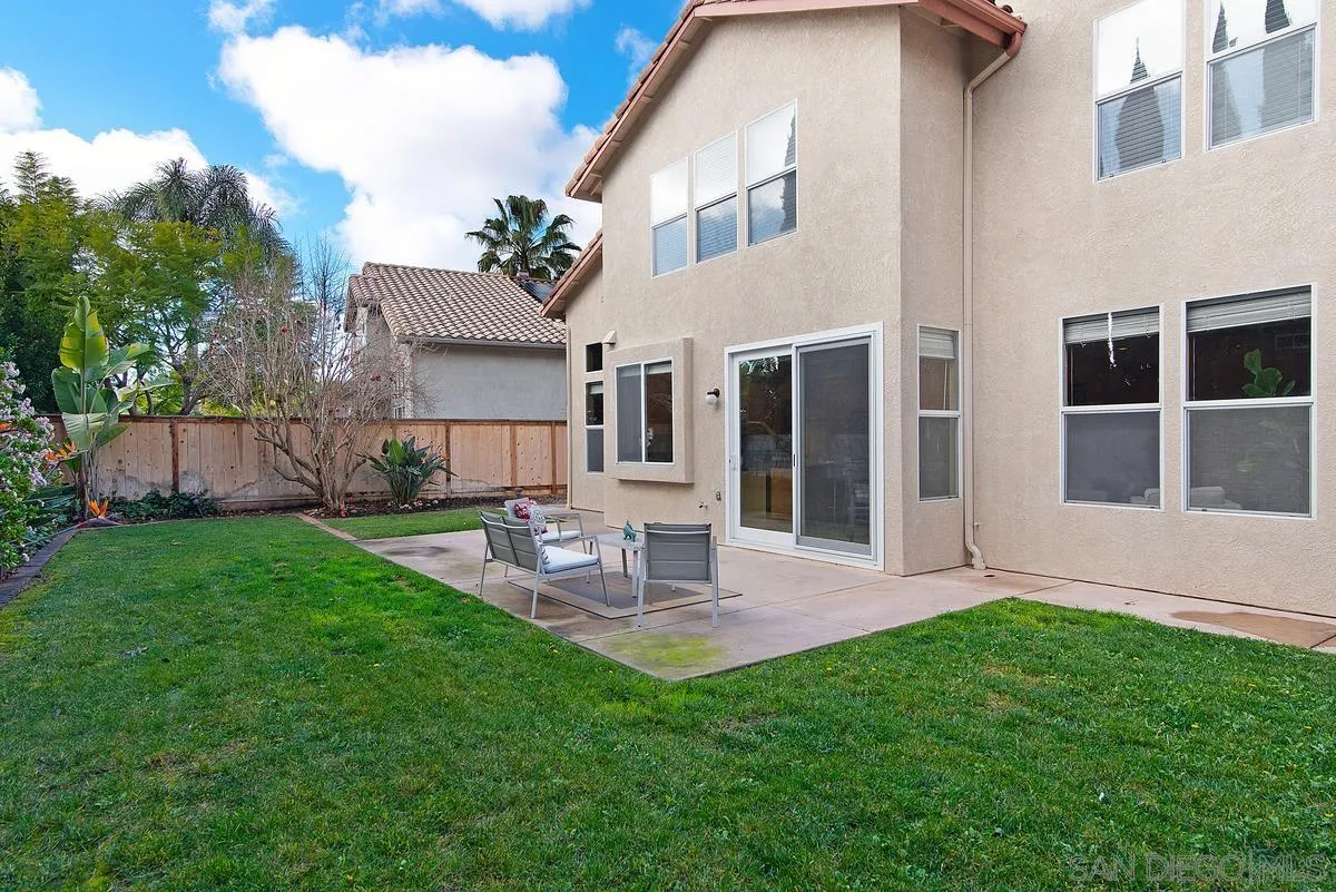 4951 Riding Ridge Road San Diego, CA 92130 - Photo 29 of 32 a view of a house with a yard and sitting area