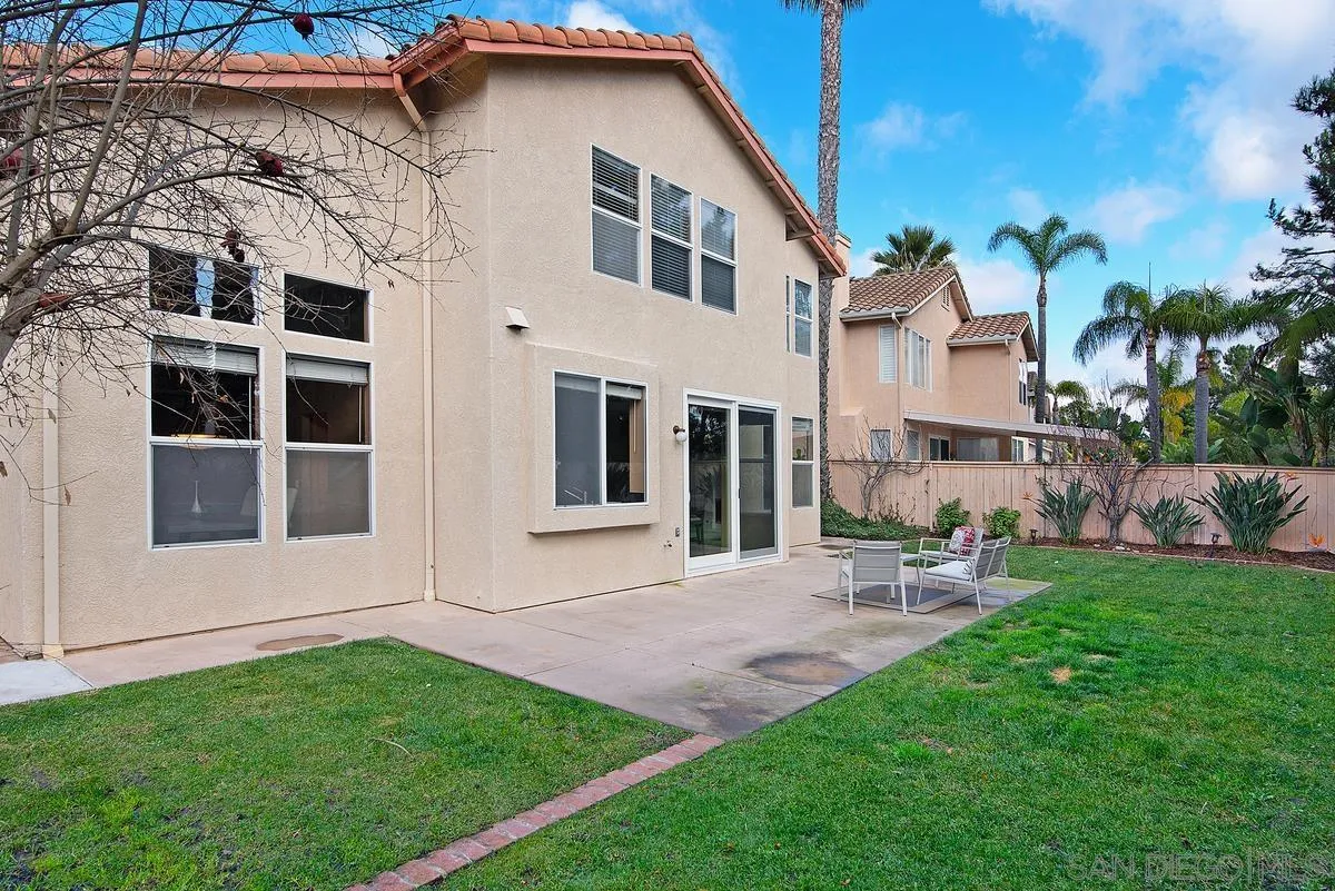 4951 Riding Ridge Road San Diego, CA 92130 - Photo 30 of 32 a front view of a house with a yard
