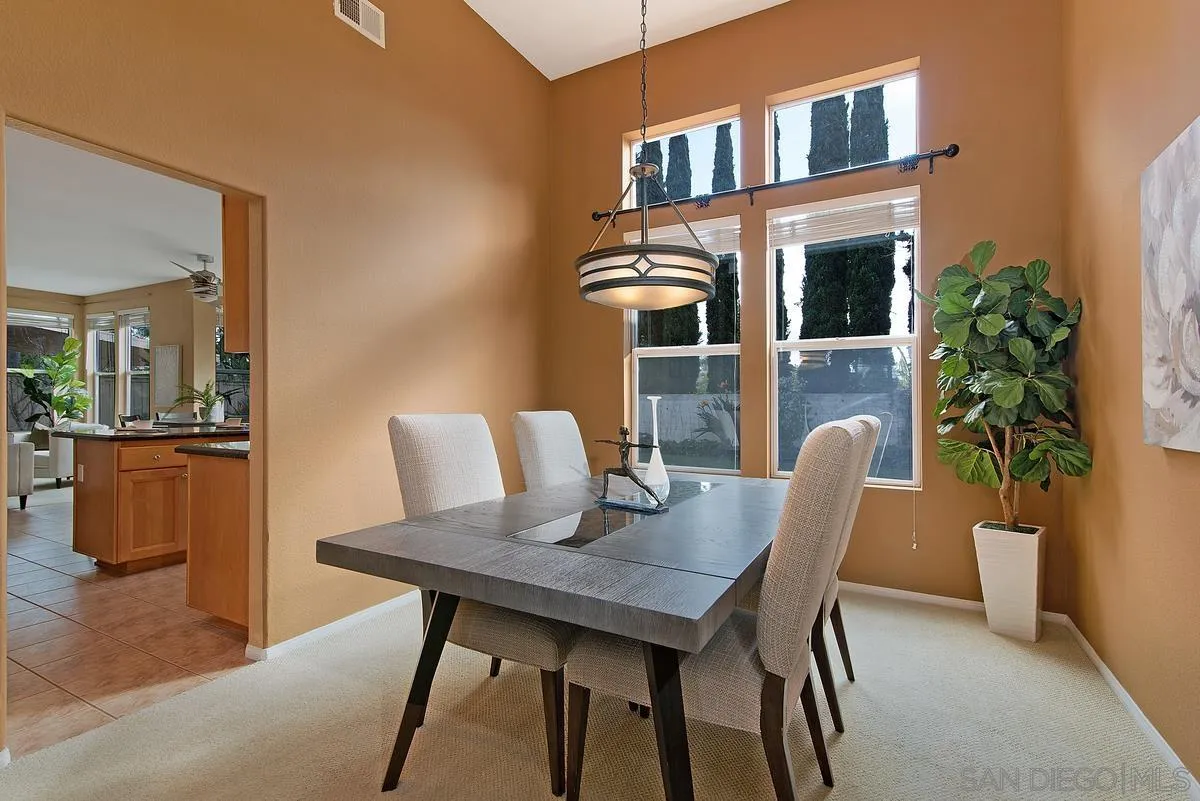 4951 Riding Ridge Road San Diego, CA 92130 - Photo 6 of 32 a view of a dining room with furniture and a potted plant