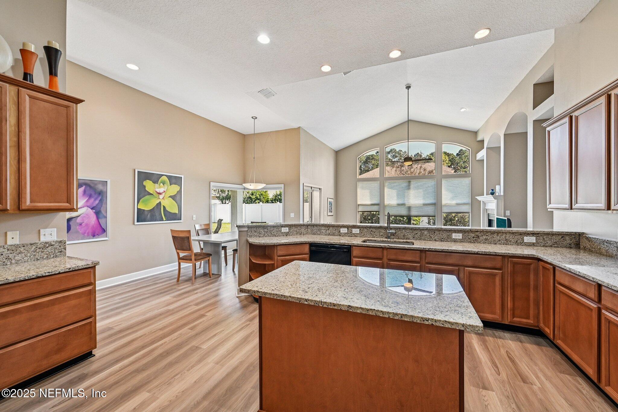 5300 Rising Sun Court St. Johns, FL 32259 - Photo 12 of 43 a large kitchen with cabinets chairs and wooden floor