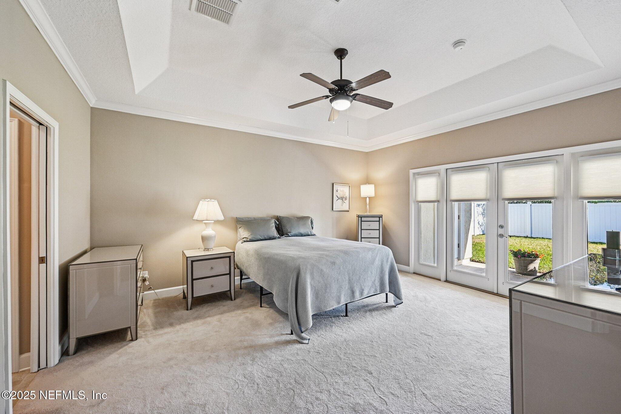 5300 Rising Sun Court St. Johns, FL 32259 - Photo 15 of 43 a spacious bedroom with a bed a couch and a window