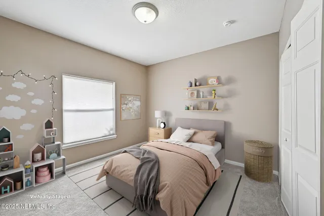 a bedroom with a bed and a large window