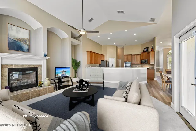 a living room with furniture and a fireplace