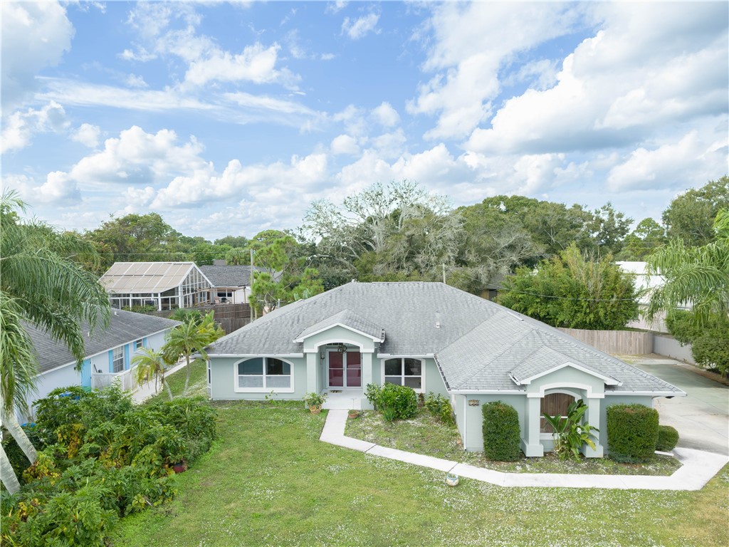 a aerial view of a house next to a yard