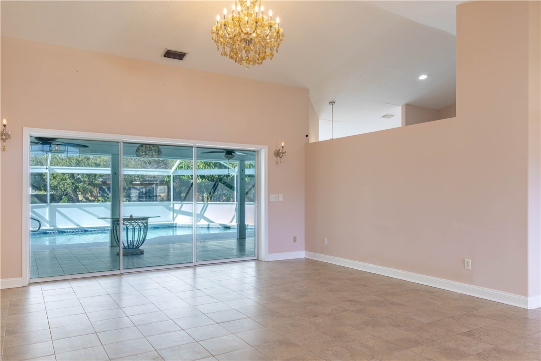 122 Coconut Street Sebastian, FL 32958 - Photo 13 of 36 a view of an empty room with a sliding door