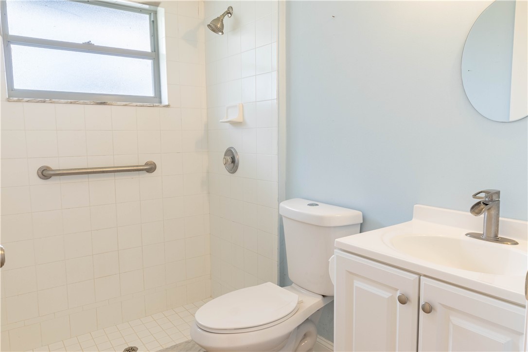 122 Coconut Street Sebastian, FL 32958 - Photo 22 of 36 a white toilet sitting next to a bathroom sink