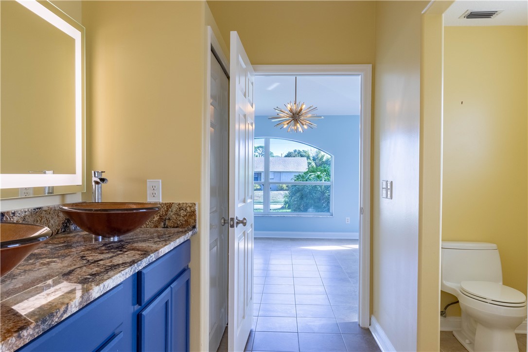 122 Coconut Street Sebastian, FL 32958 - Photo 28 of 36 a bathroom with a granite countertop sink and a shower