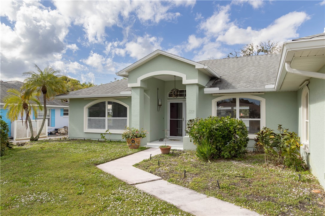 122 Coconut Street Sebastian, FL 32958 - Photo 4 of 36 a front view of a house with garden