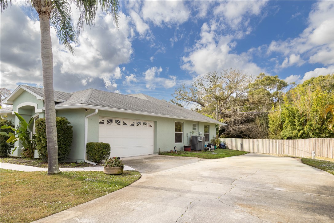 122 Coconut Street Sebastian, FL 32958 - Photo 5 of 36 a view of a white house with a road