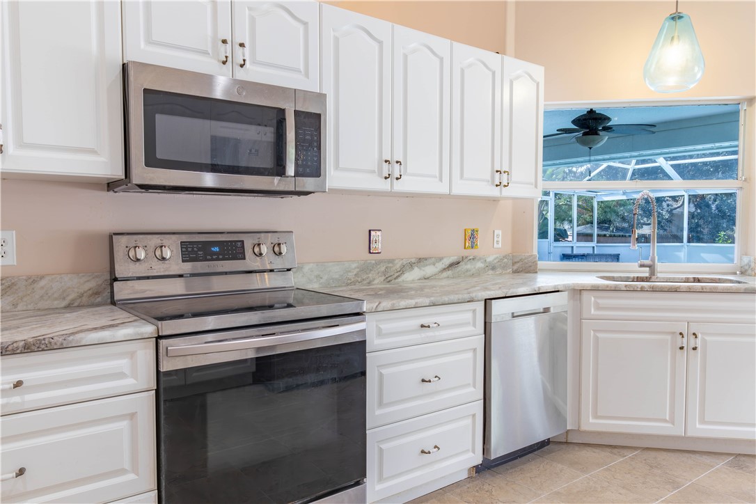 122 Coconut Street Sebastian, FL 32958 - Photo 10 of 36 a kitchen with cabinets stainless steel appliances and sink