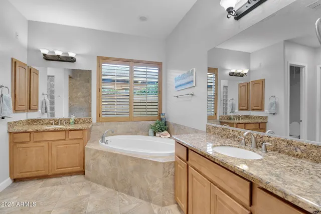 a living room with furniture a bookshelf and a window