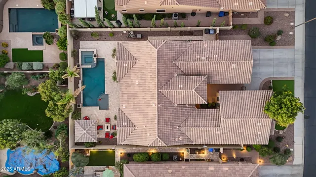 a aerial view of a house with a yard and large tree