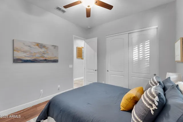 a view of a house with a yard and a large tree