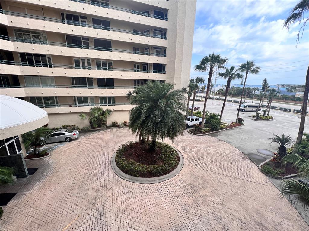 4565 South Atlantic Avenue, Unit 5203 Ponce Inlet, FL 32127 - Photo 1 of 28 a view of a swimming pool with a chair and potted plants