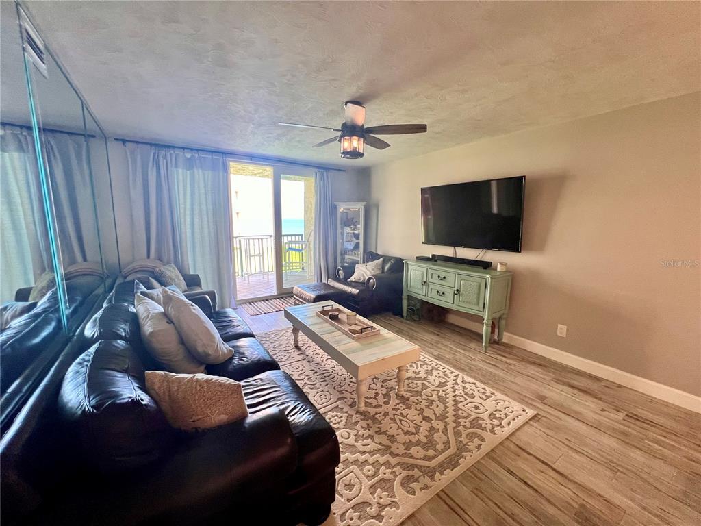 4565 South Atlantic Avenue, Unit 5203 Ponce Inlet, FL 32127 - Photo 11 of 28 a living room with furniture and a flat screen tv