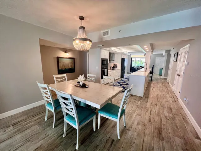 a view of a dining room with furniture wooden floor and chandelier